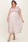 woman wearing a floral print maternity plus maxi dress with red accents and a visible baby bump