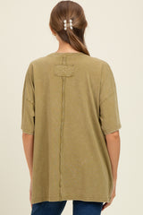 woman wearing an olive green oversized maternity t-shirt with a relaxed fit and a seam detail on the back