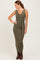 woman wearing an olive green ribbed sleeveless maxi dress with a tie waist and brown knee-high boots