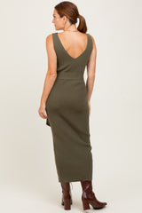 woman wearing an olive green ribbed midi dress with a deep v-back and brown knee-high boots