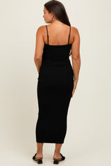 woman wearing a black ribbed maternity maxi dress with thin straps, showing a fitted silhouette from the back