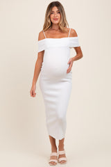 woman wearing a white off-shoulder ribbed maternity dress and holding her baby bump