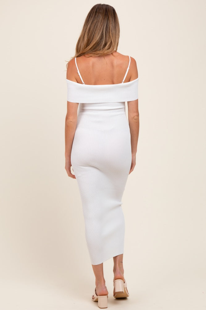 woman wearing a white off-shoulder ribbed maternity dress, showing a fitted silhouette and a mid-length style