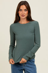 woman wearing a ribbed long sleeve green top with a classic crew neckline and slightly fitted silhouette
