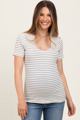woman wearing a striped short sleeve maternity top with a scoop neckline and smiling at the camera