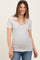 woman wearing a striped short sleeve maternity top with a scoop neckline and smiling at the camera