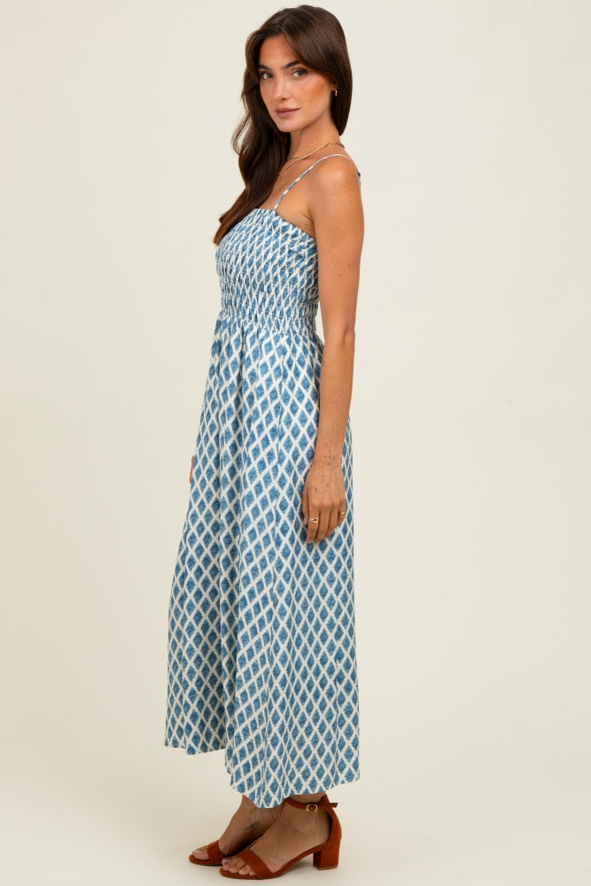 woman wearing a blue and white patterned maxi dress with spaghetti straps and a smocked bodice