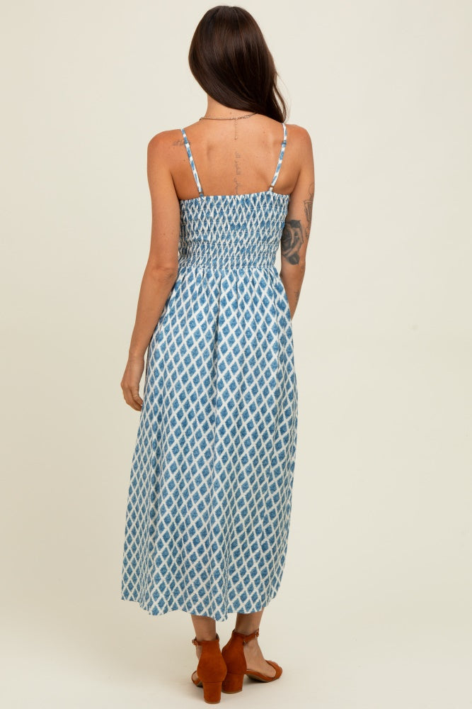 woman wearing a blue and white patterned maxi dress with adjustable straps and a smocked back
