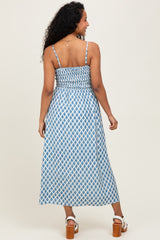 woman wearing a blue and white patterned maternity maxi dress with a ruched back and spaghetti straps