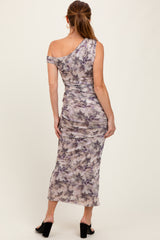 woman wearing a one-shoulder floral print maxi dress with ruched detailing and a fitted silhouette