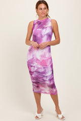 woman wearing a purple floral print midi dress with ruching detail and a sleeveless design
