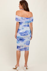 woman wearing a floral off-the-shoulder midi dress in shades of blue with gathered fabric details