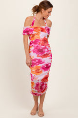 woman wearing a pink off-the-shoulder floral midi dress with ruching and a fitted silhouette