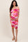 woman wearing a floral off-shoulder maternity dress with a fitted silhouette, showing her baby bump