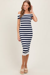 woman wearing a fitted navy and white striped off-the-shoulder dress with a ribbed hem and espadrille sandals