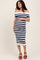 woman wearing a navy and white striped off-the-shoulder maternity dress and holding her baby bump
