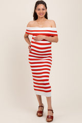 woman wearing a red and white striped off-shoulder maternity dress and holding her baby bump