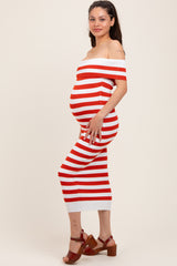 woman wearing a red and white striped off-the-shoulder maternity dress, highlighting her baby bump