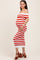 woman wearing a red and white striped off-the-shoulder maternity dress, highlighting her baby bump