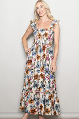 woman wearing a floral print maxi dress with ruffled straps and a tiered design
