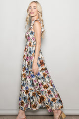 woman wearing a floral maxi dress with ruffle straps and a tiered design
