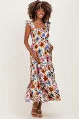 woman wearing a floral print maternity maxi dress with ruffled straps and a visible baby bump