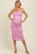 woman wearing a pink strapless maternity dress that highlights her baby bump