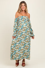 woman wearing a floral off-the-shoulder maternity maxi dress with long sleeves and a visible baby bump