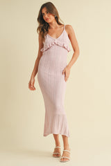 woman wearing a light pink knitted maxi dress with ruffle detail and straps