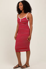 woman wearing a red and white striped midi dress with spaghetti straps and a fitted silhouette