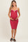 woman wearing a red and white striped maternity dress and holding her baby bump