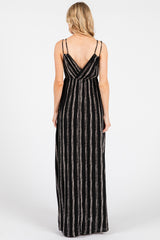 woman wearing a black and white striped maxi dress with thin adjustable straps viewed from the back