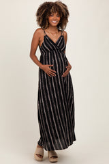 woman wearing a black and white striped maternity maxi dress, showing her baby bump with a relaxed fit