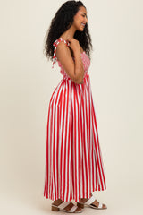 woman wearing a red and white striped maxi dress with smocked bodice and adjustable tie straps