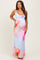woman wearing a light blue maternity maxi dress with a floral print and ruched sides, showcasing her baby bump