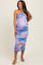 woman wearing a colorful maternity dress with a halter neck and a form-fitting style, showcasing a baby bump