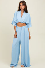 woman wearing a light blue cropped top and matching wide-leg pants