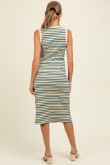 woman wearing a striped maternity midi dress with a fitted silhouette and sleeveless design, showing her baby bump