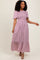 woman wearing a floral print pink maxi dress with short sleeves and tiered detailing