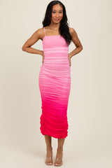 woman wearing a pink ombre ruched midi dress with spaghetti straps and a fitted silhouette