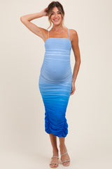 woman wearing a light blue ombre maternity dress with ruching and a visible baby bump