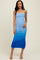 woman wearing a blue ombre ruched midi dress with adjustable spaghetti straps