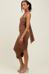 woman wearing a brown ruched bodycon dress with a high neckline and flowing back detail