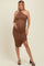 woman wearing a brown one-shoulder ruched maternity dress and showing her baby bump