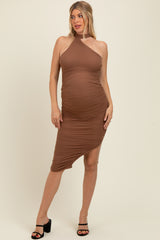 woman wearing a brown maternity dress with an asymmetrical hem and a fitted silhouette, showcasing her baby bump