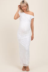 woman wearing a white lace off-shoulder maternity gown and showing her baby bump