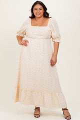 woman wearing a cream floral maxi dress with puff sleeves and a square neckline, styled with strappy black heels