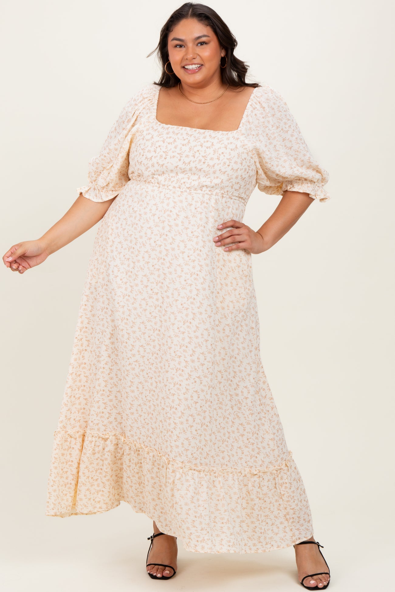 plus size woman wearing a light floral maxi dress with a square neckline and puff sleeves
