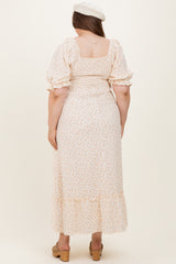 woman wearing a floral maternity plus dress with a square neckline and puff sleeves, showing a baby bump from the back