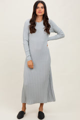 woman wearing a light gray ribbed long sleeve maxi dress and black slip-on shoes
